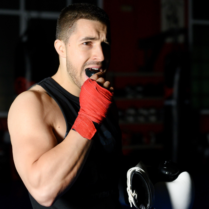 Athlete putting on mouthguard