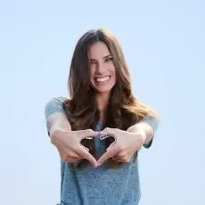 smiling girl heart hands